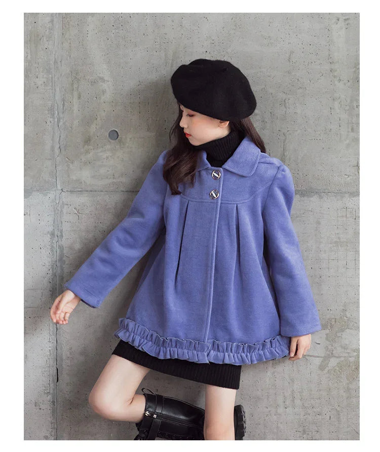 Girl wearing a loose-fit lavender wool coat with ruffle hem, black beret, and boots
