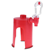 Red plastic beverage dispenser with spout and clear handle on white background