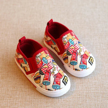Colorful slip-on canvas sneakers with red trim, cartoon fast food print, and white rubber soles.