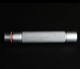 Silver cylindrical metal accessory with knurled texture and red ring, on black background