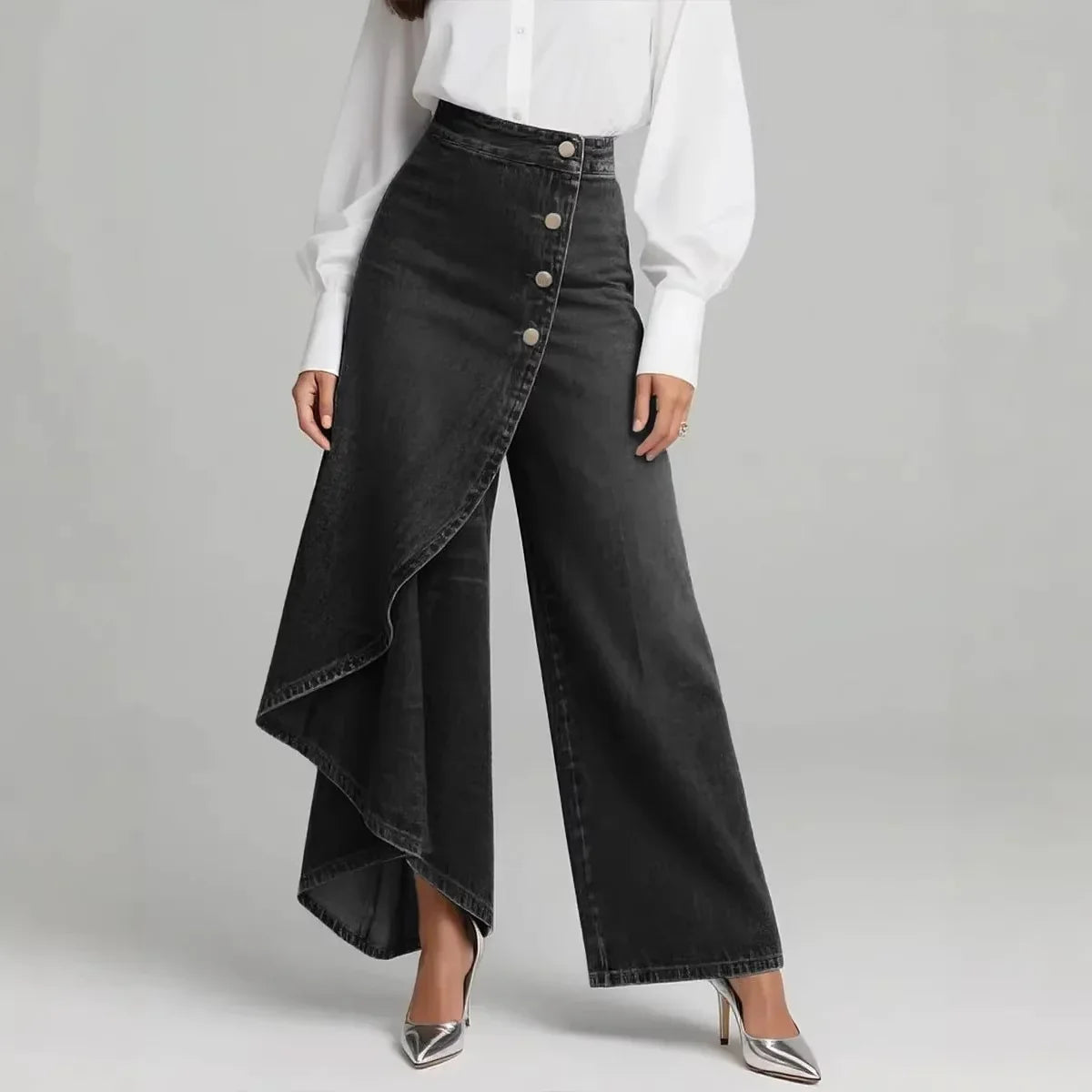 High-waisted black denim wide-leg pants with asymmetrical buttoned skirt overlay, relaxed fit
