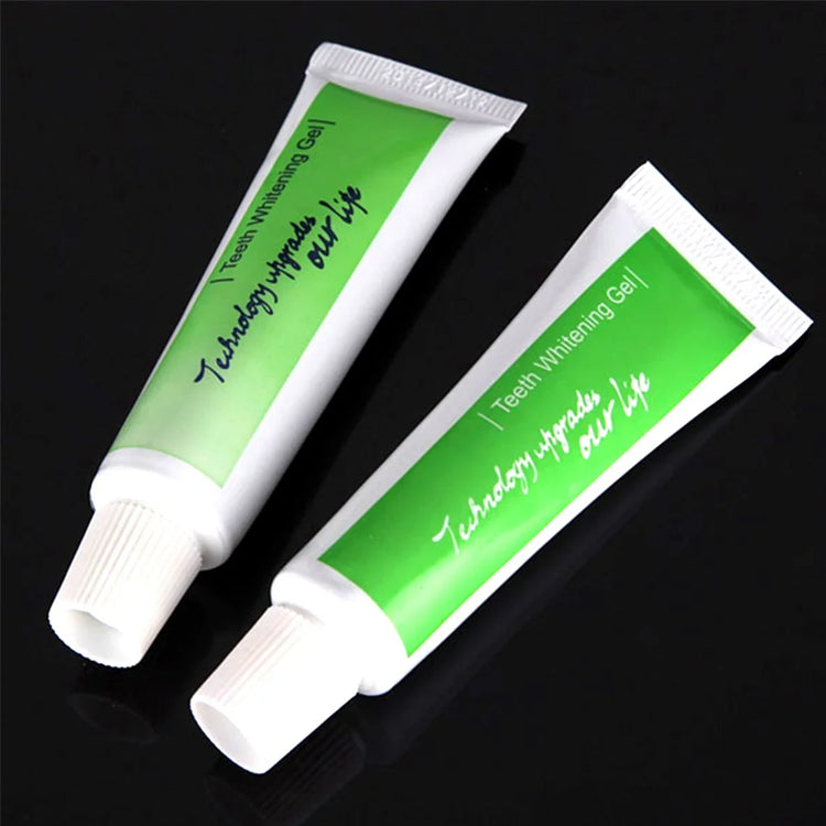 Two tubes of teeth whitening gel with green labels on a black background