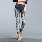 Woman wearing high-waisted black and white octopus print leggings, form-fitting style.