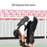 Man wearing black padded streetwear vest and leg guards, stretching outdoors