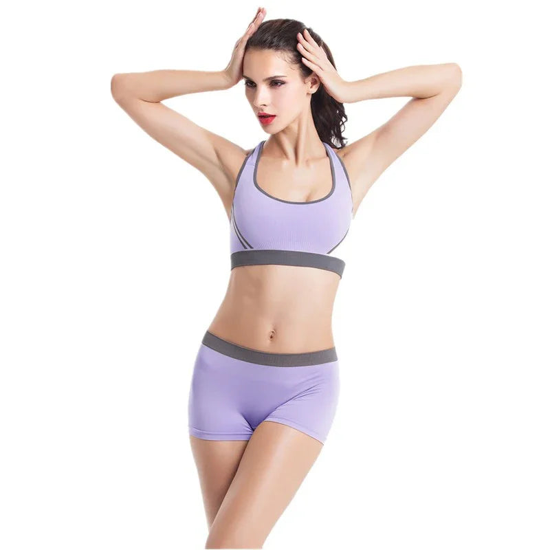 Woman wearing lavender sports bra and matching shorts with gray trim, fitted activewear set