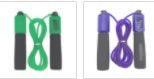 Two jump ropes with foam handles, one green and black, one purple and black, on white background.