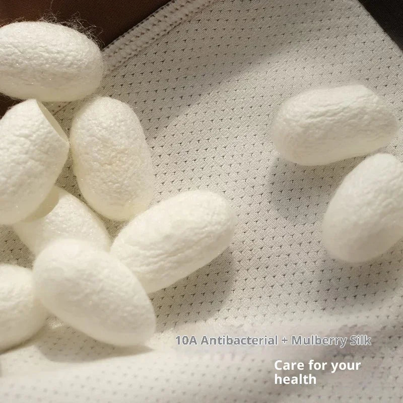 White mulberry silk cocoons on textured antibacterial white fabric, premium clothing material