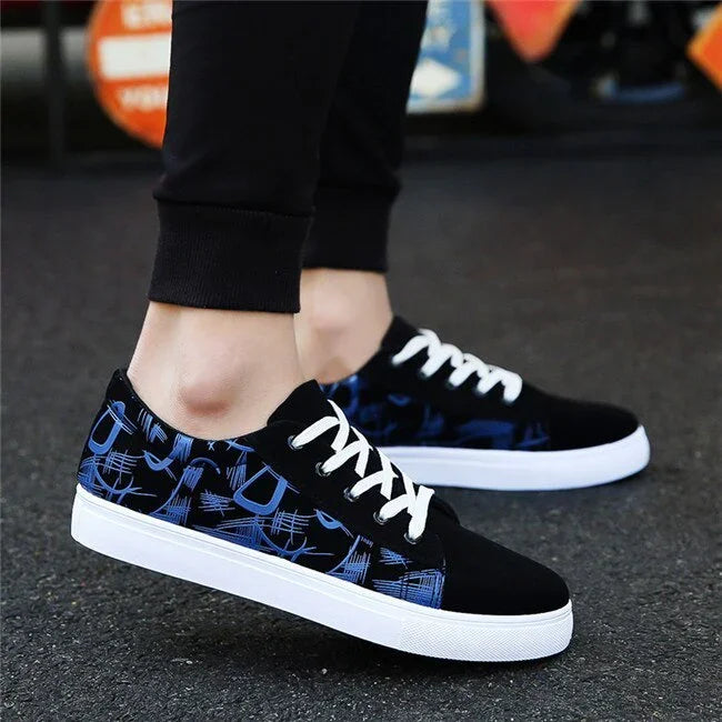 Black low-top sneakers with blue abstract pattern, white soles, white laces, casual fit