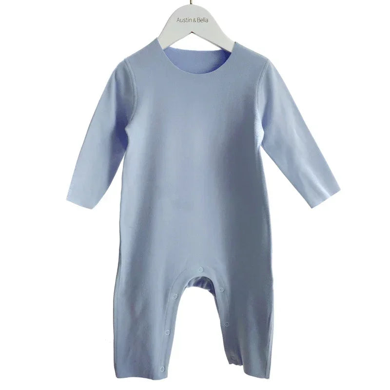 Light blue long sleeve baby jumpsuit with snap buttons, soft cotton fabric, relaxed fit
