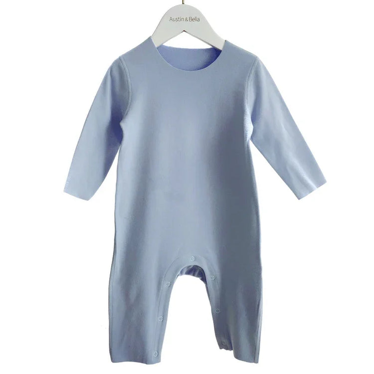 Light blue long sleeve baby jumpsuit with snap buttons, soft cotton fabric, relaxed fit