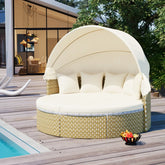 Beige round outdoor daybed with canopy, wicker base, and white cushions by a poolside