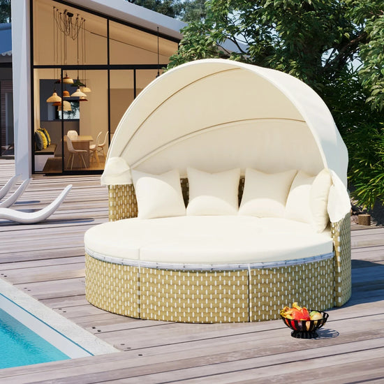 Beige round outdoor daybed with canopy, wicker base, and white cushions by a poolside
