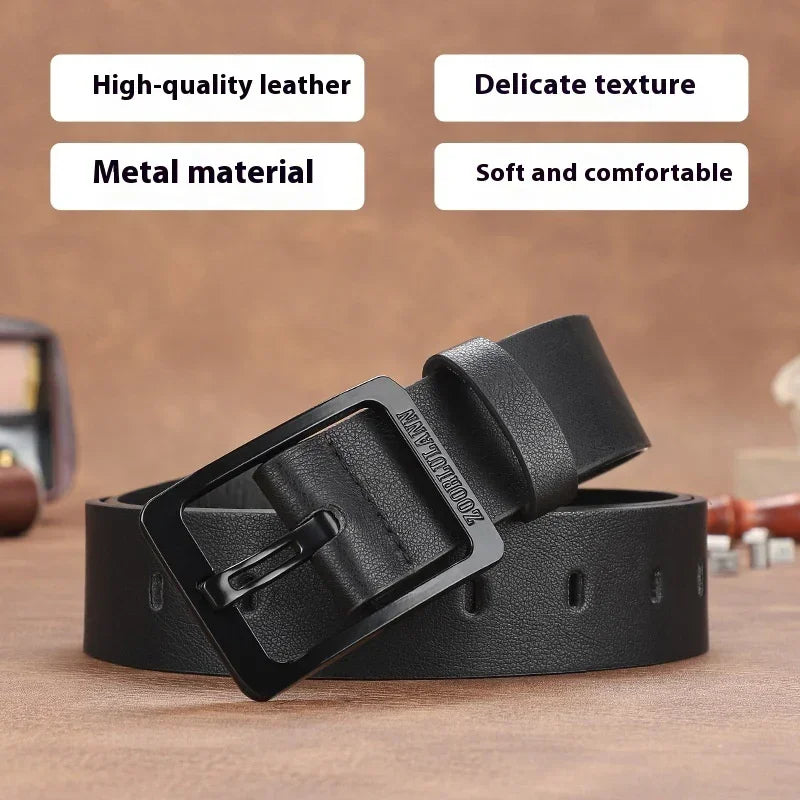 Black leather belt with a matte finish and metal square buckle on a wooden surface.