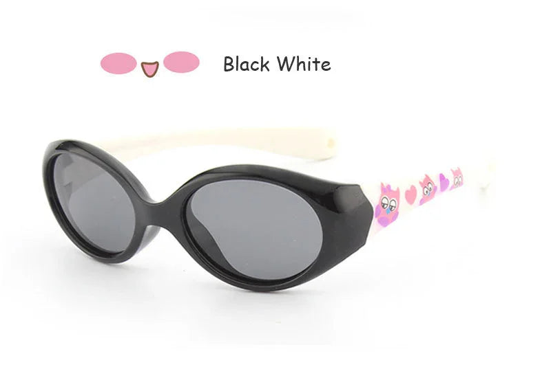 Black and white oval sunglasses with pink cartoon cat design on white arms, glossy finish.