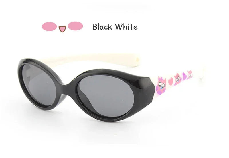 Black and white oval sunglasses with pink cartoon cat design on white arms, glossy finish.