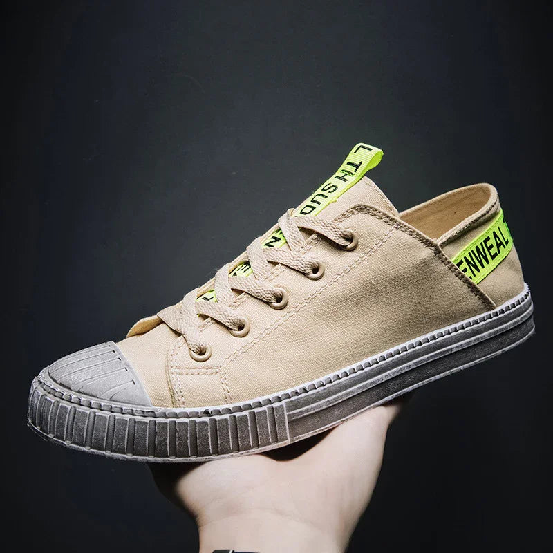 Beige canvas low-top sneaker with neon green accents and rubber sole, casual streetwear style