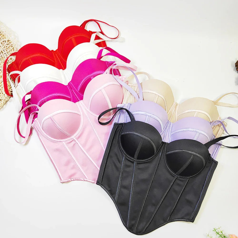 Assorted satin corset tops in black, red, white, pink, and beige with structured fit