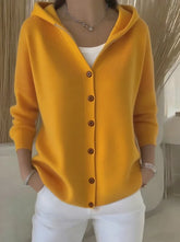 Yellow button-up knit hoodie, relaxed fit, long sleeves, styled with white pants.