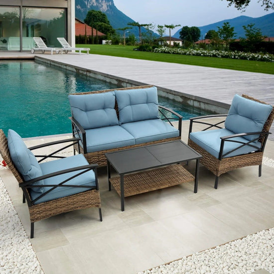 Outdoor patio set with light blue cushions, wicker frame, and black metal arms by a pool