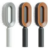 Three modern oval hair brushes with ergonomic handles in grey, black, and brown colors