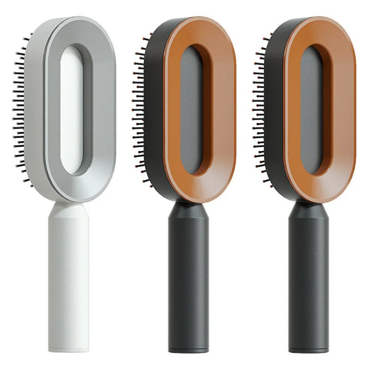 Three modern oval hair brushes with ergonomic handles in grey, black, and brown colors