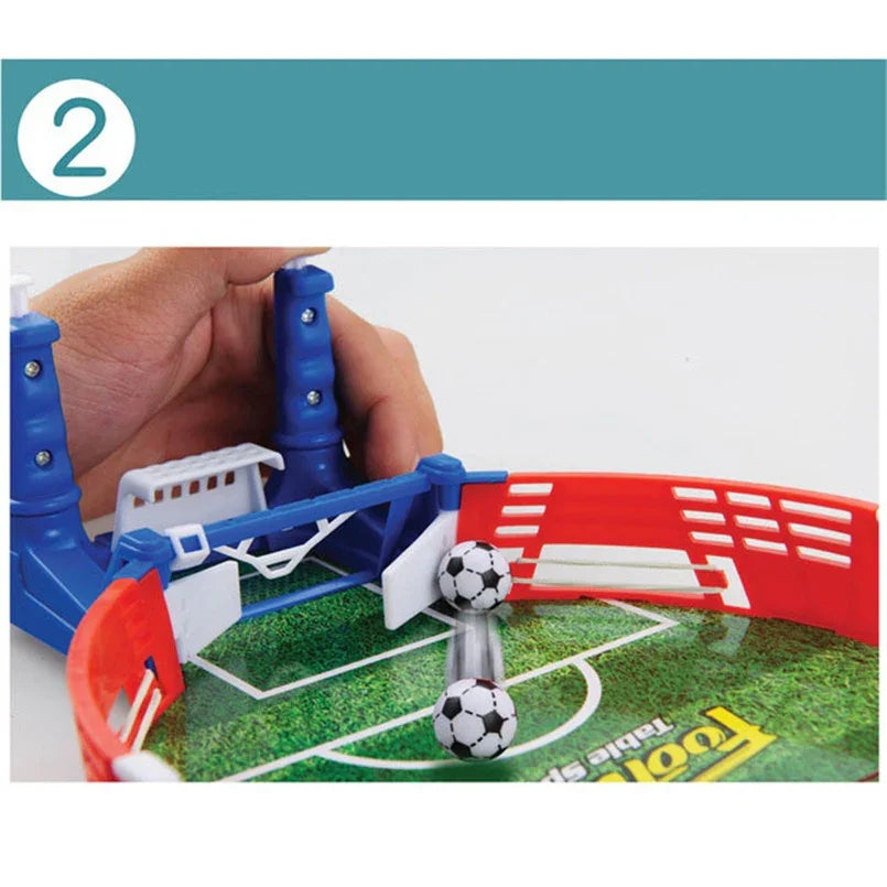 Mini tabletop soccer game with plastic field, red and blue barriers, and small soccer balls