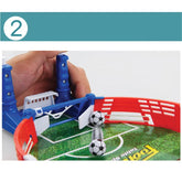 Mini tabletop soccer game with plastic field, red and blue barriers, and small soccer balls