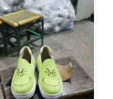 Lime green slip-on canvas shoes with cartoon face print, casual streetwear style