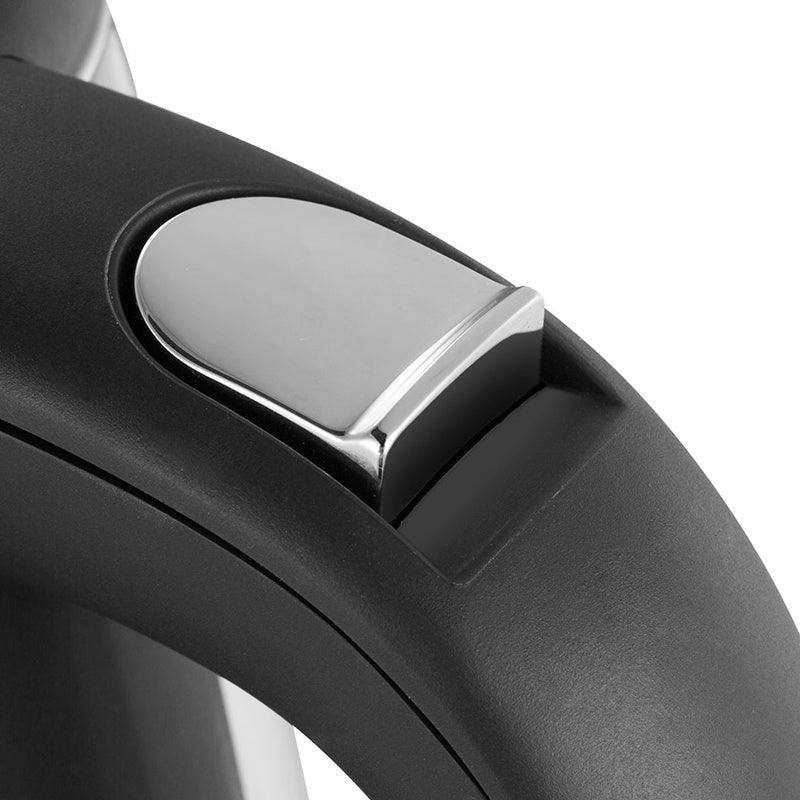 Close-up of a modern electric kettle handle in matte black plastic with metallic accent