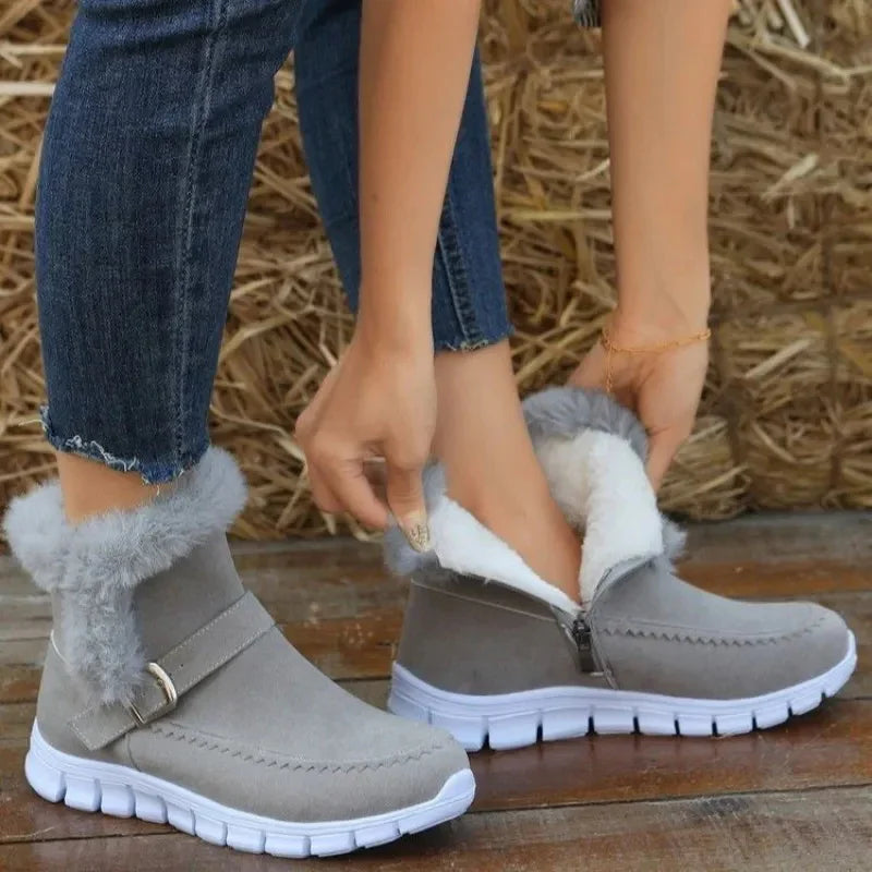 Gray faux fur lined ankle boots with side zipper, white soles, paired with blue skinny jeans