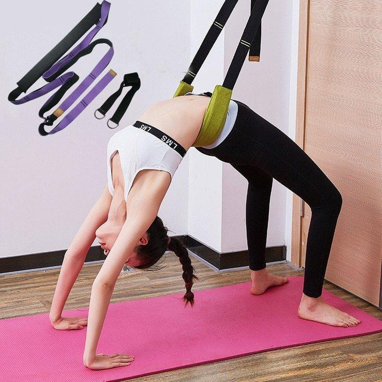 Woman in white crop top and black leggings doing backbend yoga pose with support strap on pink mat