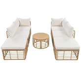 Beige rattan outdoor lounge set with white cushions and round wicker coffee table