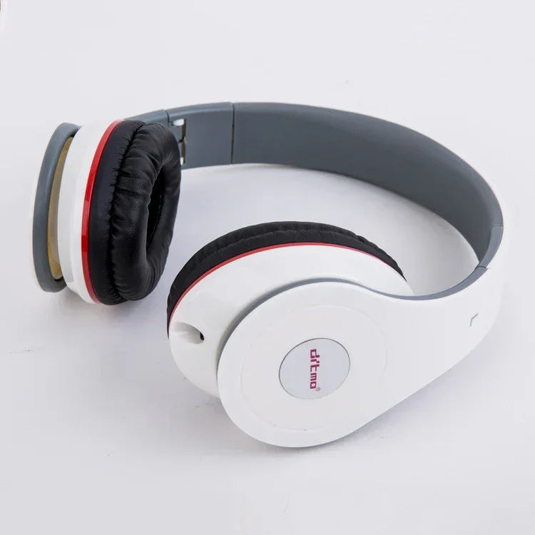 White over-ear headphones with black cushioned ear pads and red accent rings