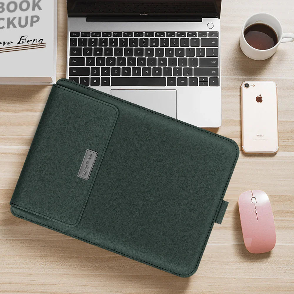 Dark green leather laptop sleeve on desk with laptop, smartphone, and coffee cup
