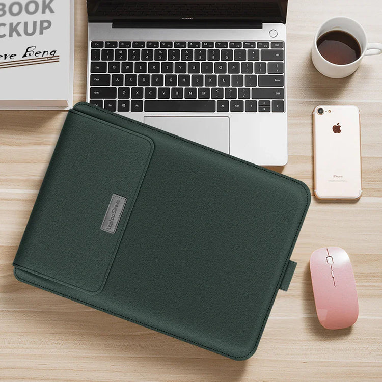 Dark green leather laptop sleeve on desk with laptop, smartphone, and coffee cup