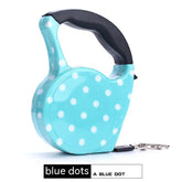 Light blue retractable leash with white polka dots and a black ergonomic handle