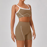 Woman wearing fitted brown athletic shorts and sports bra with white trim and stitching.