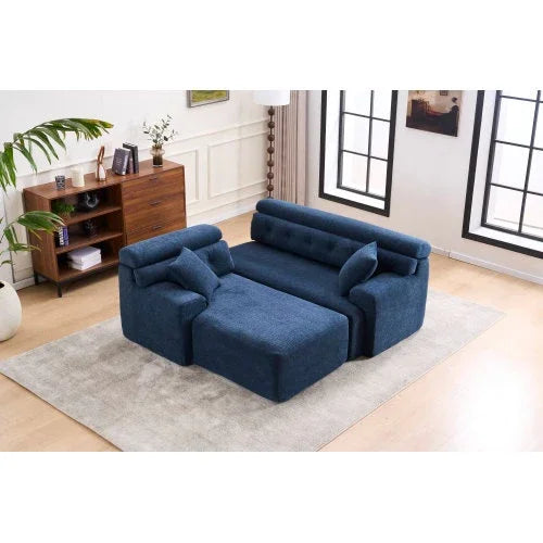 Modern blue upholstered sectional sofa with plush cushions and chaise lounge on a beige rug