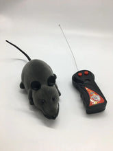Grey remote control toy mouse with black ears and long tail on white background