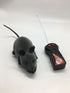 Grey remote control toy mouse with black ears and long tail on white background