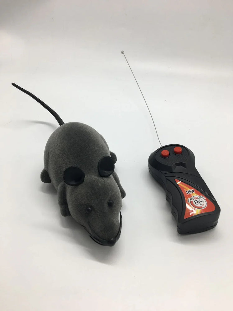 Grey remote control toy mouse with black ears and long tail on white background