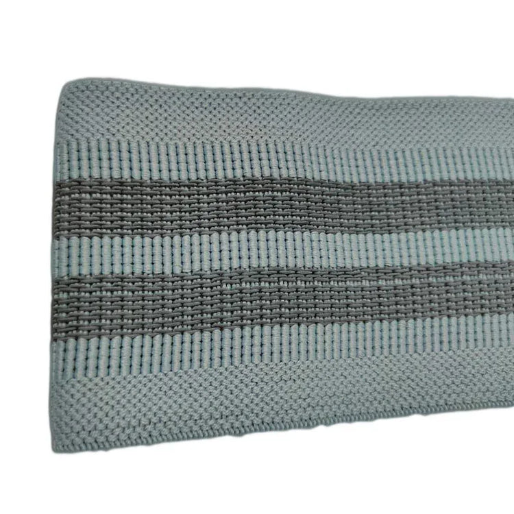 Close-up of light blue and gray ribbed knit fabric with horizontal textured stripes