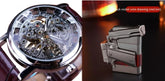 Close-up of a skeleton dial wristwatch with brown leather strap and a metallic gun-shaped lighter.