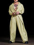 Man wearing oversized light yellow streetwear shirt and wide-leg pants with relaxed fit