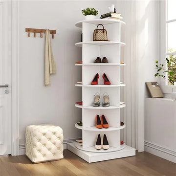 Modern white rotating corner shoe rack with multiple shelves holding various stylish shoes.