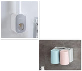 Bathroom wall-mounted organizer with toothpaste dispenser and pastel blue and pink cups