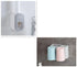Bathroom wall-mounted organizer with toothpaste dispenser and pastel blue and pink cups