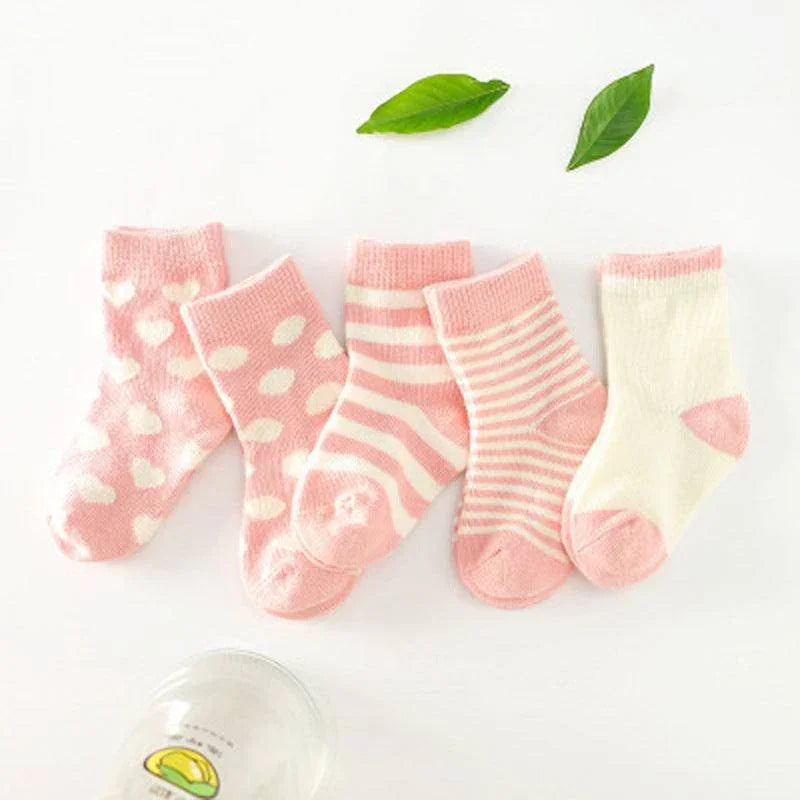 Set of soft cotton baby socks in pink and white, with polka dot and striped patterns.