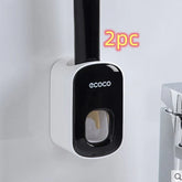White and black wall-mounted plastic holder with mop handle inserted, modern bathroom accessory