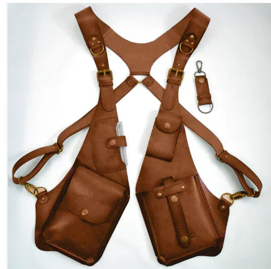 Brown leather harness vest with multiple pockets and brass hardware, adjustable fit.